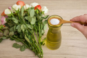 Person adding white flower food powder inside cut flower vase so cut flowers last longer fresh.