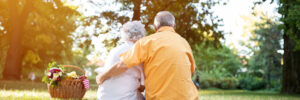 Happy and lovely senior couple enjoying a picnic in the park