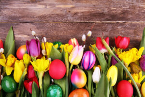 Easter eggs spread across Easter flowers